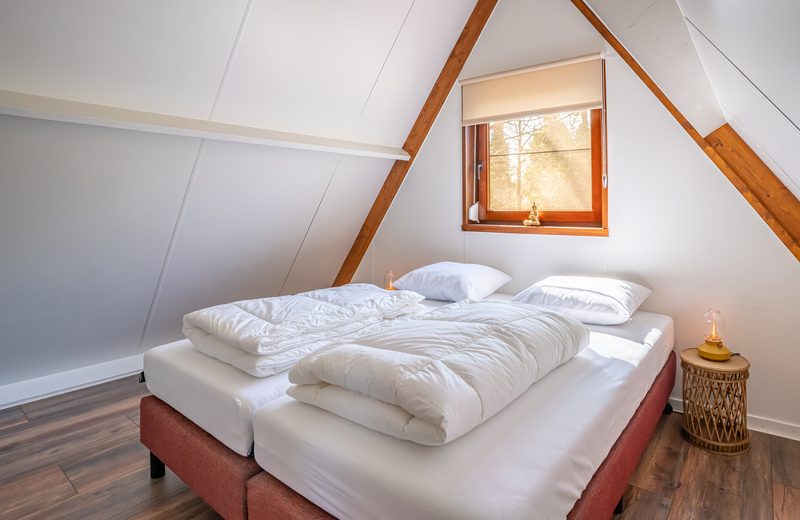 Slaapkamer met bed bij een dakraam
